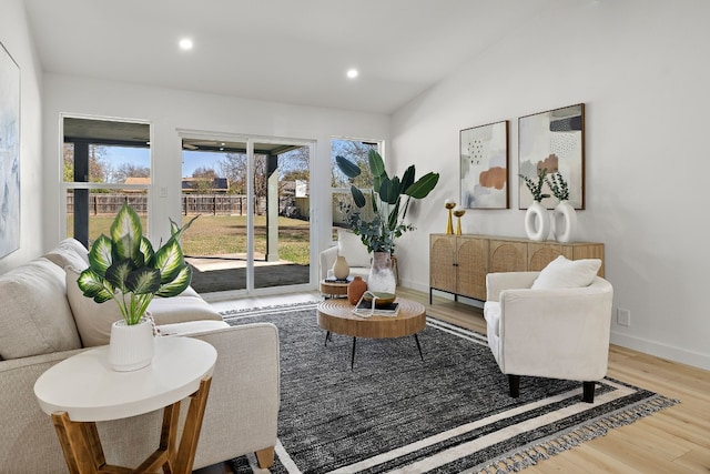 living room featuring hardwood / wood-style floors and vaulted ceiling