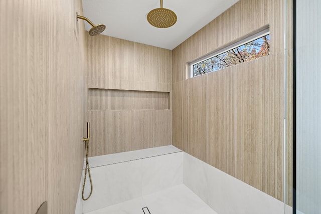 bathroom with tiled shower