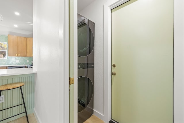 laundry room with stacked washer and clothes dryer