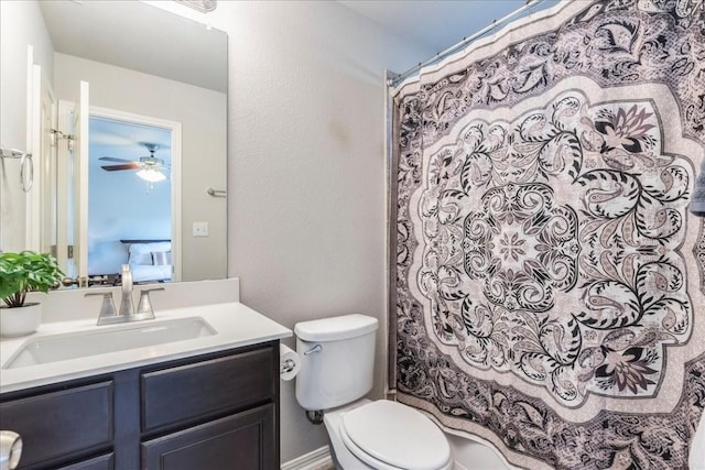 bathroom featuring curtained shower, ceiling fan, vanity, and toilet