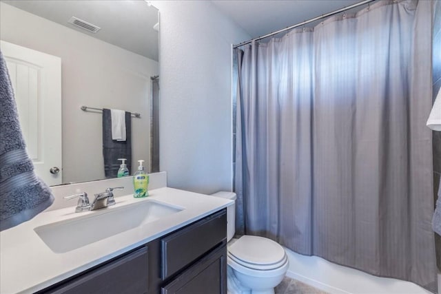 full bathroom featuring vanity, shower / bath combination with curtain, and toilet