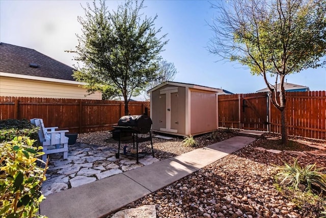 view of patio with a shed and a grill