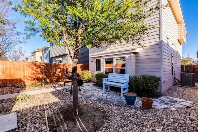 rear view of property with central AC and a patio area