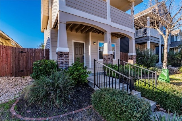 view of exterior entry featuring a balcony