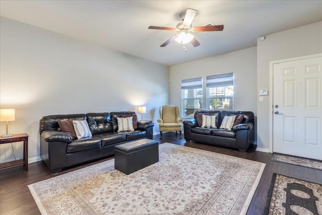 living room featuring ceiling fan and dark hardwood / wood-style floors