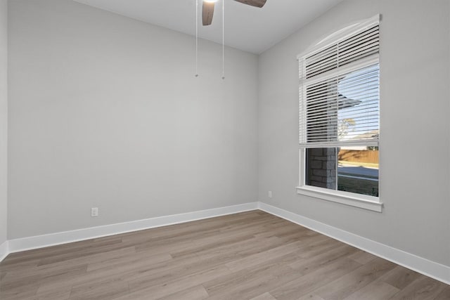 spare room with ceiling fan and light wood-type flooring