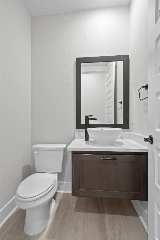 bathroom featuring hardwood / wood-style floors, vanity, and toilet