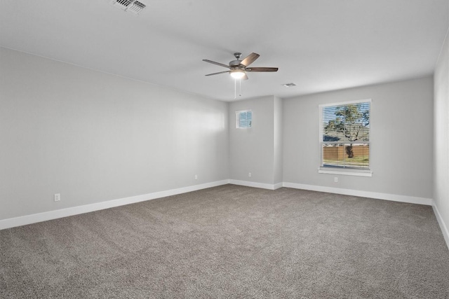 spare room with ceiling fan and carpet