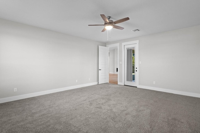 spare room featuring carpet and ceiling fan