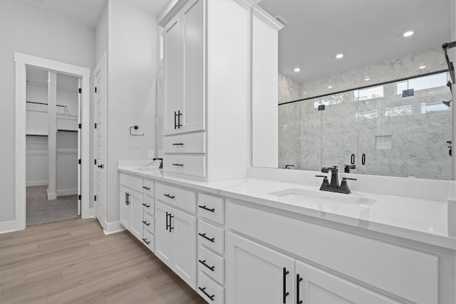 bathroom featuring vanity, hardwood / wood-style flooring, and walk in shower