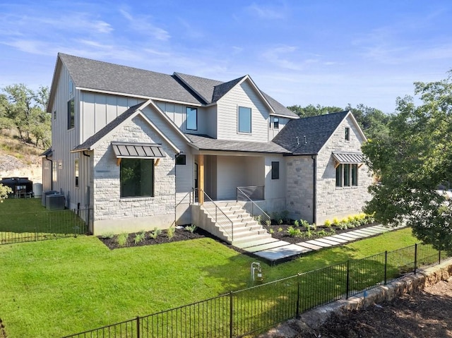 view of front of home featuring central AC and a front lawn