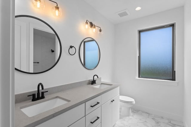 bathroom featuring vanity and toilet