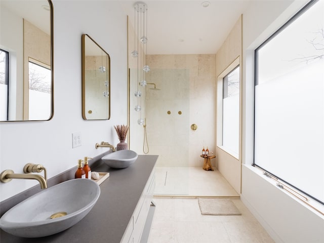 bathroom featuring a tile shower and sink