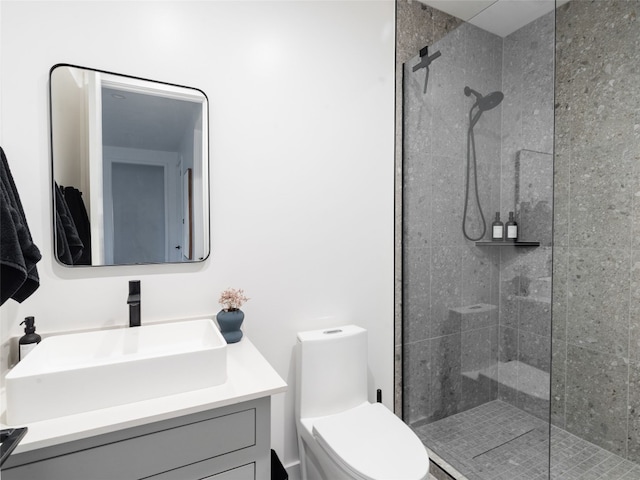 bathroom featuring vanity, toilet, and a shower with door