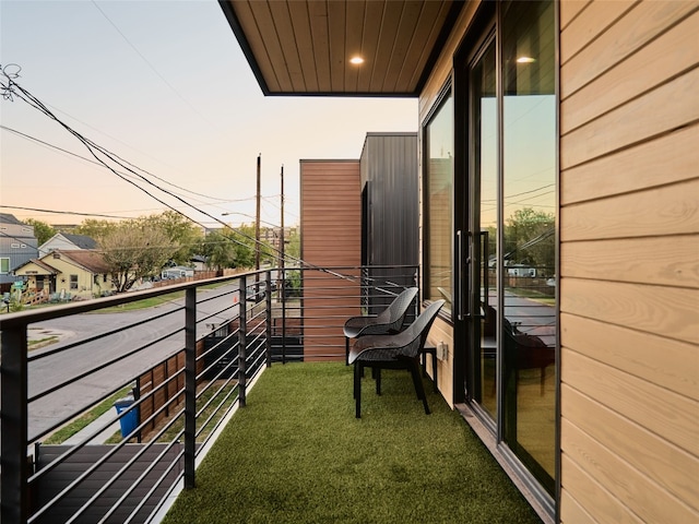 view of balcony at dusk