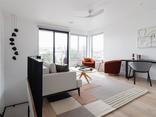 living room featuring ceiling fan and hardwood / wood-style flooring