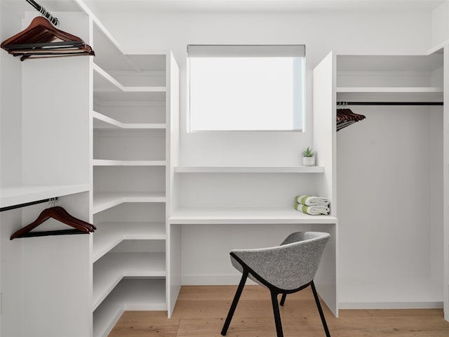 spacious closet with light hardwood / wood-style floors