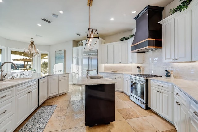 403 Rough Hollow Cv, Austin, TX 78734 - kitchen featuring a sink, custom exhaust hood, appliances with stainless steel finishes, decorative backsplash, and white cabinetry