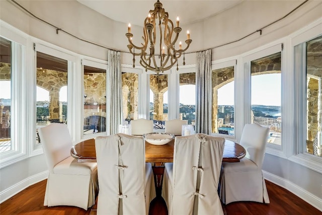 403 Rough Hollow Cv, Austin, TX 78734 - dining room featuring baseboards, a chandelier, and wood finished floors