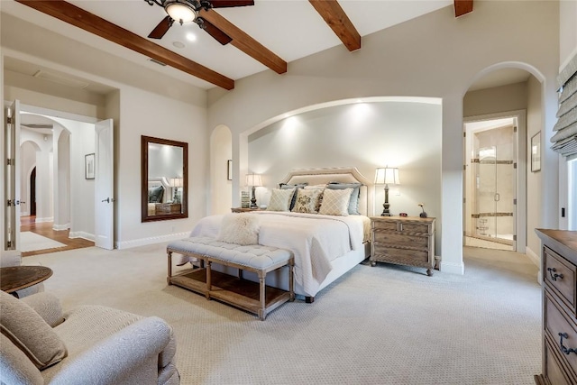403 Rough Hollow Cv, Austin, TX 78734 - bedroom with arched walkways, light carpet, beamed ceiling, baseboards, and ensuite bath