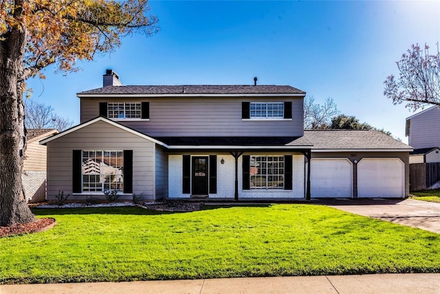 front of property with a garage and a front lawn