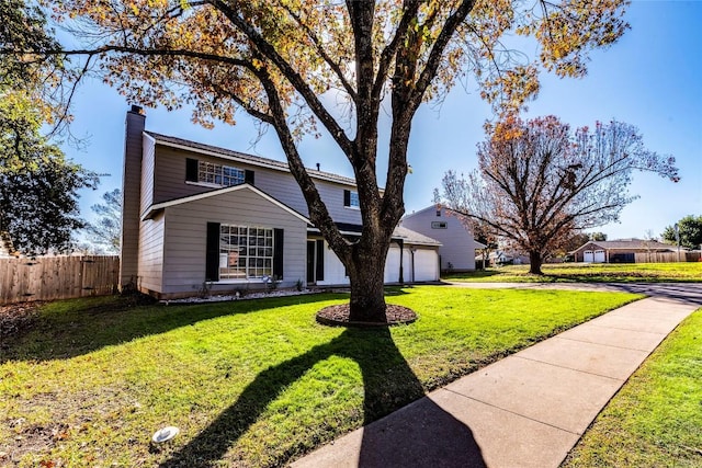 view of front property with a garage and a front lawn