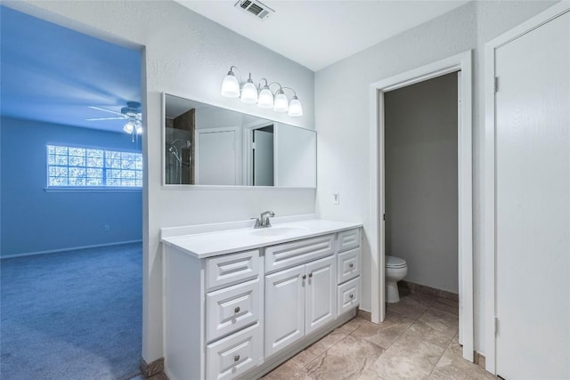 bathroom with ceiling fan, vanity, and toilet