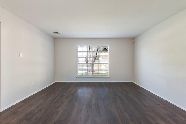 empty room featuring dark hardwood / wood-style flooring