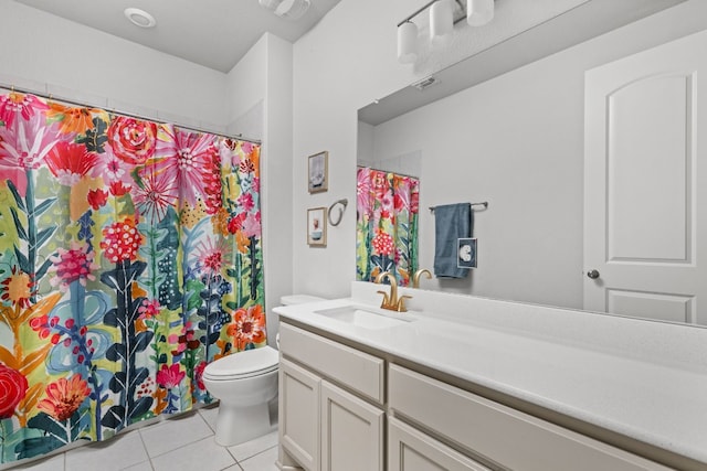 bathroom featuring vanity, tile patterned floors, and toilet