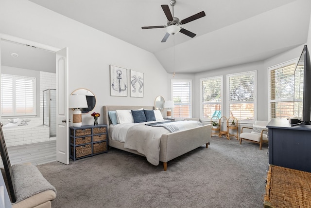 carpeted bedroom featuring lofted ceiling, multiple windows, ceiling fan, and ensuite bathroom