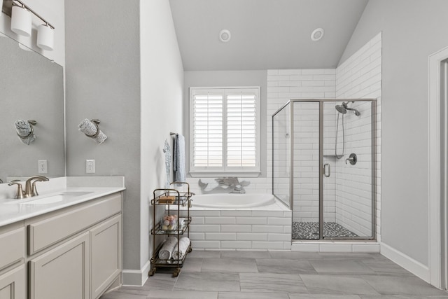 bathroom with vanity, tile patterned flooring, vaulted ceiling, and shower with separate bathtub