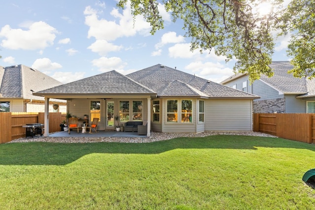 rear view of house featuring a patio, a yard, and an outdoor hangout area