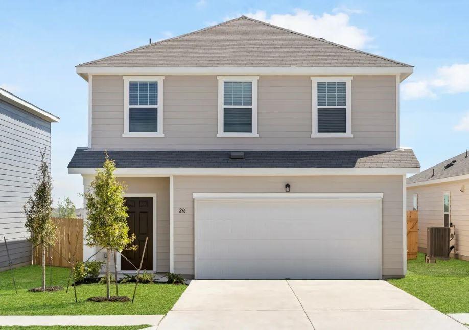 front facade with a front yard and a garage