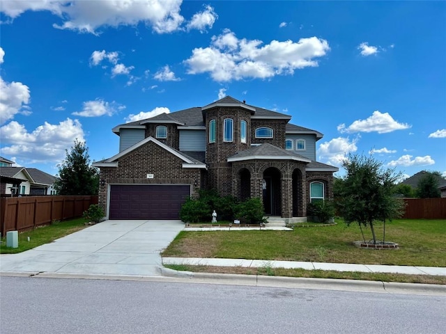 view of front of house with a garage and a front lawn