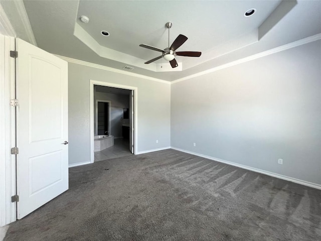 carpeted empty room with ceiling fan, crown molding, and a tray ceiling