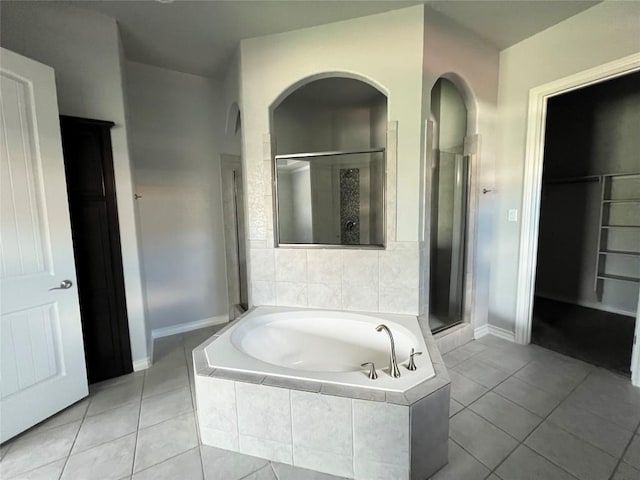 bathroom with tile patterned flooring and shower with separate bathtub