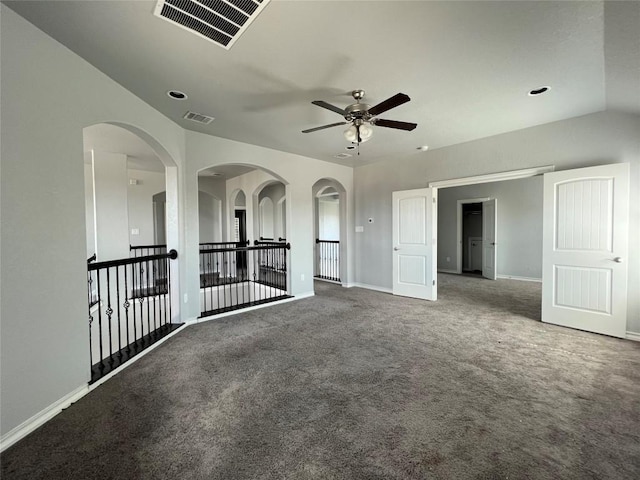 carpeted spare room featuring ceiling fan and lofted ceiling