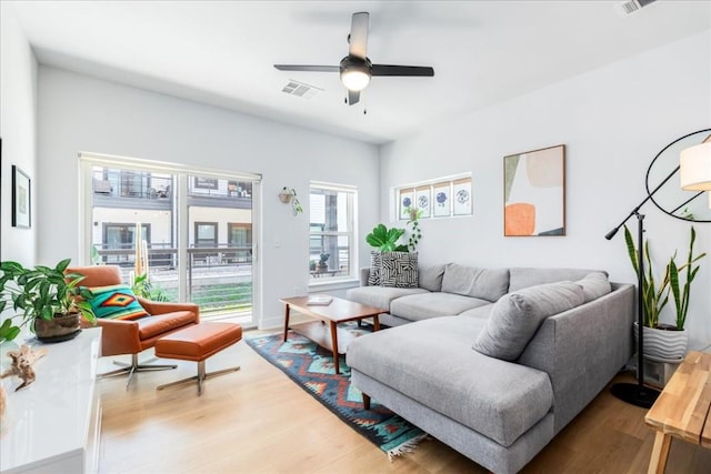 living room with ceiling fan and light hardwood / wood-style floors