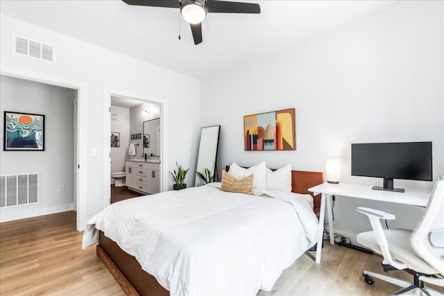 bedroom with ensuite bathroom, light hardwood / wood-style flooring, and ceiling fan