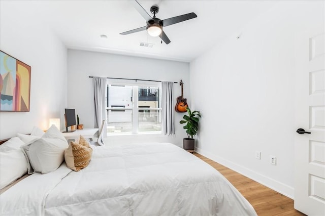 bedroom with ceiling fan and hardwood / wood-style flooring