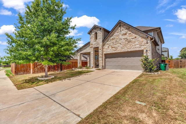 view of front of house with a front yard and a garage