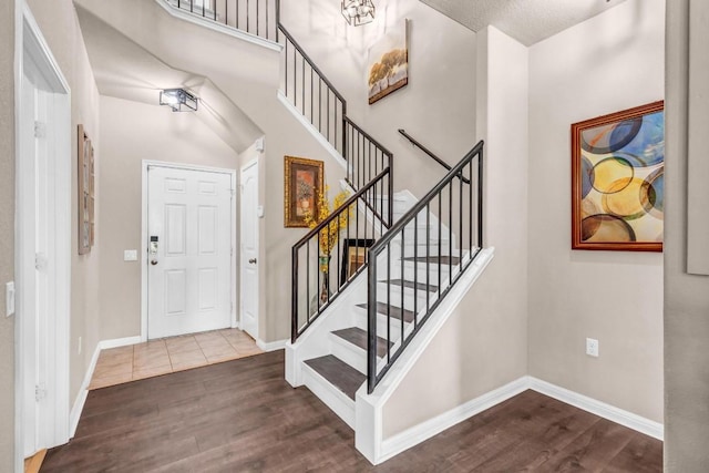 foyer entrance with a chandelier, a textured ceiling, and hardwood / wood-style flooring