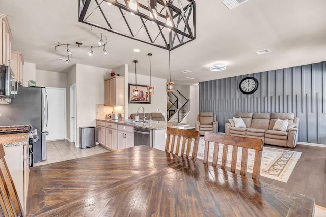 dining area with light wood-type flooring and sink