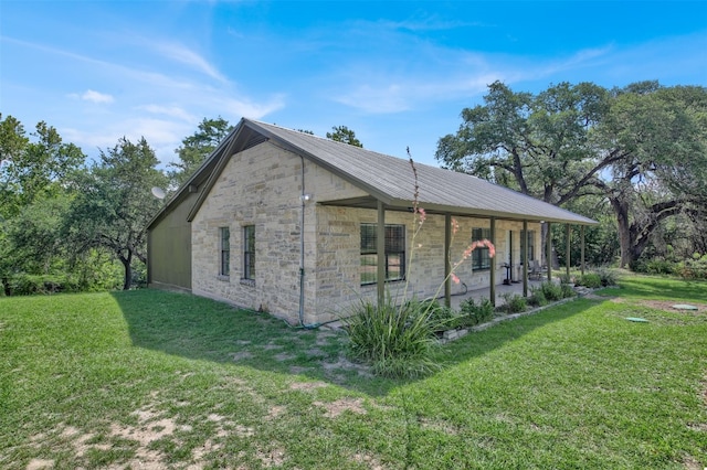 view of side of property featuring a porch and a yard