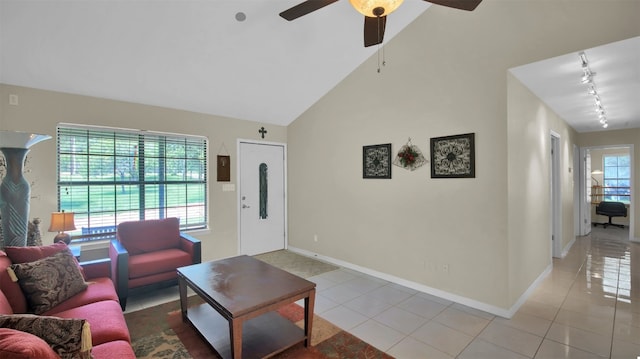 tiled living room featuring ceiling fan, lofted ceiling, and track lighting