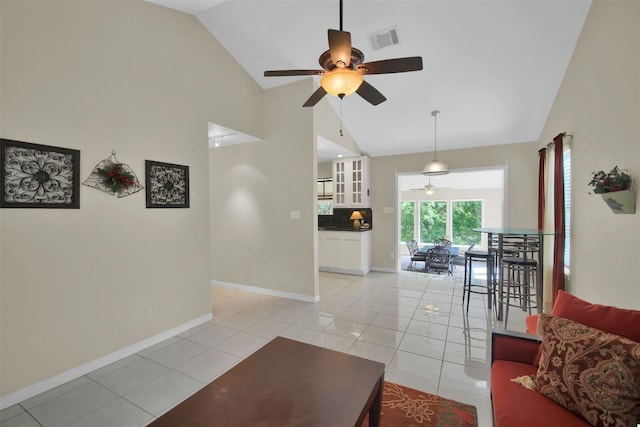 living room featuring high vaulted ceiling, ceiling fan, and light tile patterned flooring