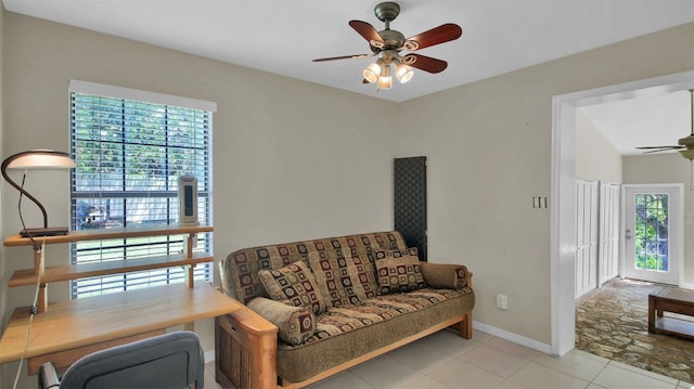 sitting room with ceiling fan and light tile patterned floors