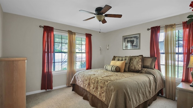 bedroom featuring ceiling fan and light carpet