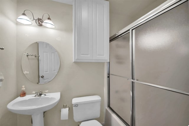 full bathroom featuring shower / bath combination with glass door, toilet, and sink