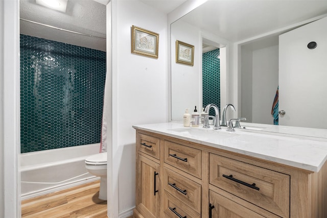 full bath featuring toilet, shower / bath combo with shower curtain, wood finished floors, and vanity